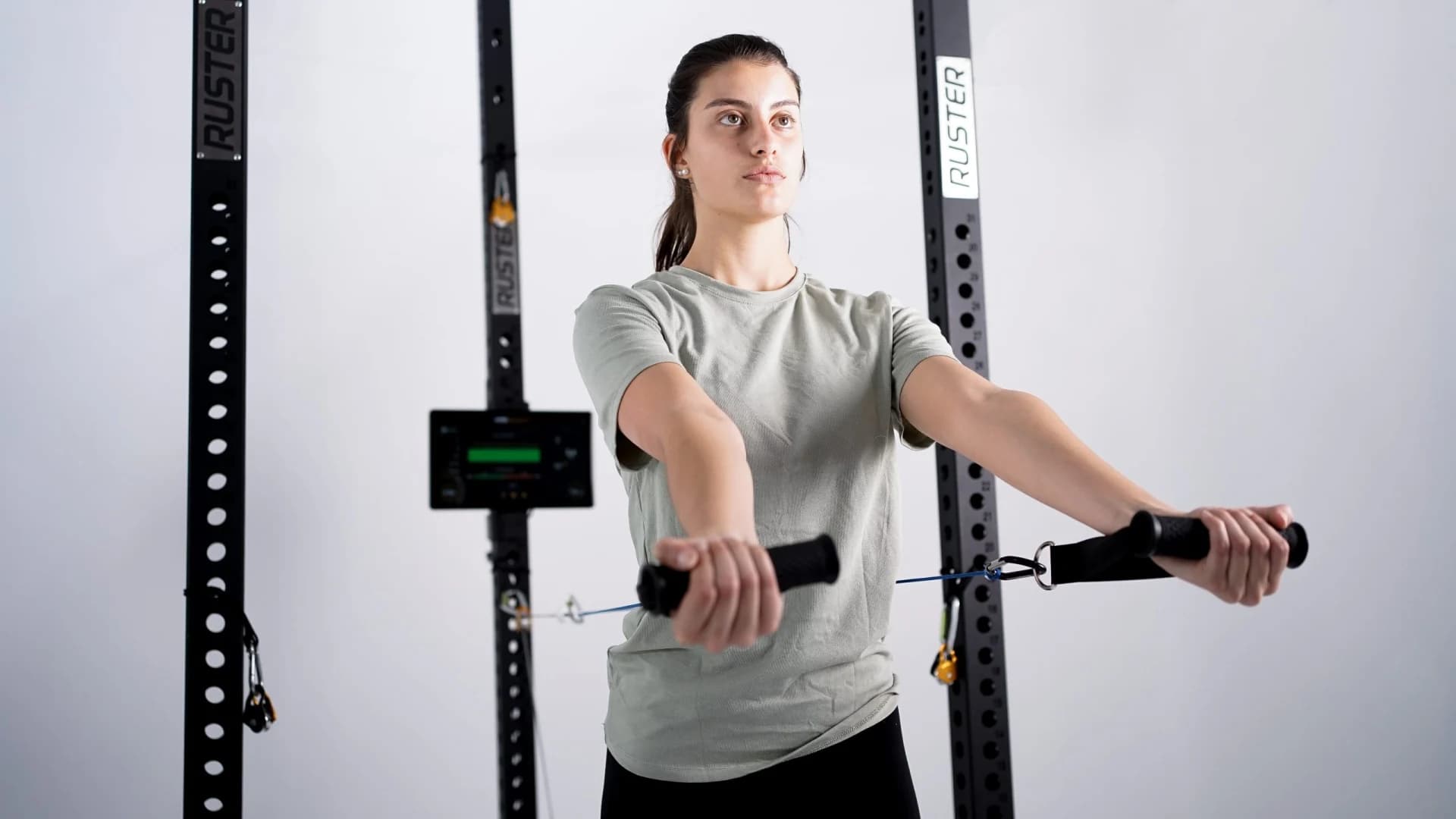 Athlete training a bilateral push on the M1 with real-time force and velocity readout.
